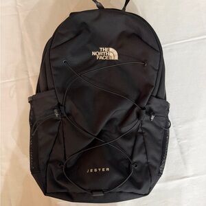 The North Face Jester Backpack in Black and gold metallic